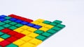 Colorful matching blocks like tetris on white background, high contrast colours, red blue yellow and green transparent tiles Royalty Free Stock Photo