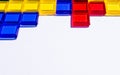 Colorful matching blocks like tetris on white background, high contrast colours, red blue yellow and green transparent tiles Royalty Free Stock Photo