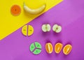 Colorful math fractions and apples, oranges, banana as a sample on yellow purple background. Interesting fun math for kids.