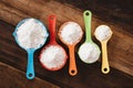 Colorful measuring cups with flour on wooden table Royalty Free Stock Photo