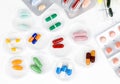 Colorful medical capsules in Petri dishes.