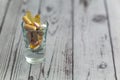 Colorful medical pills, capsules and tablets in shot glass on grey table. Color photo. Royalty Free Stock Photo