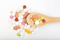 Colorful medical pills on spoon and capsules or supplements for therapy in background, concept of treatment and health care Royalty Free Stock Photo