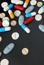 Colorful medicine pills on dark background, vertical