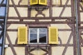 Colorful medieval wall of old half-timbered house with  wooden windows , close-up Royalty Free Stock Photo