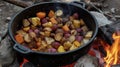 A colorful medley of root vegetables and wild mushrooms cooked in a rustic Dutch oven over a flickering fire. The Royalty Free Stock Photo