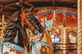 Colorful merry-go-round with bright colorful Horses closeup, holiday, Christmas market, selective focus