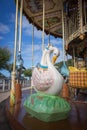 Colorful merry go round with swan figure. Empty vintage carousel in park. Retro roundabout. Fairground carousel. Childhood. Royalty Free Stock Photo