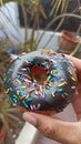 Colorful Meses Donut in The Right Hand Royalty Free Stock Photo