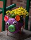 Colorful metal pig with yellow flowers