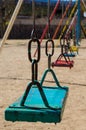 Colorful metal swings at a children's playground Royalty Free Stock Photo