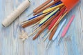 Colorful metal and wooden natural bamboo crochet hooks and needles on the table. Various sizes. Creative work place for homemade c