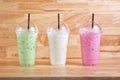 Colorful milk beverages on wood background