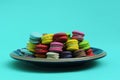 Colorful of mini macaroon cookie dessert food on blue lights backgrounds