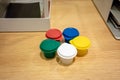 Colorful mini plastic cup with cap on wood table.