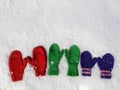 Colorful mittens on snow