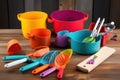 colorful mix of cooking utensils, including pots and pans, bowls, spoons, and knives