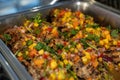 colorful mix of mango salsa covered fish or chicken protein on a platter ready to be served to the private event on a boat