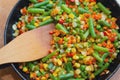 Colorful mix of vegetables is fried in a frying pan close up Royalty Free Stock Photo