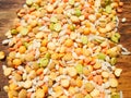 Colorful mixed cereals and legumes: rice, peas, lentils and pearl barley on a wooden background. View from above. Empty space for Royalty Free Stock Photo