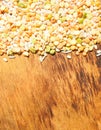 Colorful mixed cereals and legumes: rice, peas, lentils and pearl barley on a wooden background. View from above. Empty space for Royalty Free Stock Photo