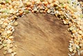 Colorful mixed cereals and legumes: rice, peas, lentils and pearl barley on a wooden background. View from above. Empty space for Royalty Free Stock Photo