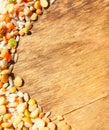 Colorful mixed cereals and legumes: rice, peas, lentils and pearl barley on a wooden background. View from above. Empty space for Royalty Free Stock Photo