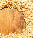 Colorful mixed cereals and legumes: rice, peas, lentils and pearl barley on a wooden background. View from above. Empty space for Royalty Free Stock Photo