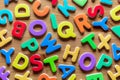 Colorful mixed letters pile on a wooden table