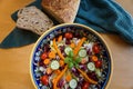 Artistic, inviting bowl of salad with rustic loaf of bread