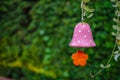 Colorful mobile flower shapes made of ceramic hanging in garden