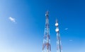 Colorful mobile phone network telecommunication tower against blue sky. Royalty Free Stock Photo