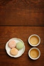 Colorful mochi rice cake on white plate and porcelain cups with Royalty Free Stock Photo