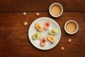 Colorful mochi rice cakes on white plate, porcelain cups with gr Royalty Free Stock Photo