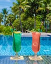 colorful mocktail at a pool bar, orange and green cocktail by the pool Royalty Free Stock Photo