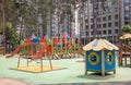A colorful modern playground in the yard in a park without people. Children`s playground in a public park surrounded by green tree Royalty Free Stock Photo
