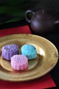 Colorful Mooncake on Golden Plate with Tea Pot on Background