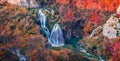 Colorful morning view of pure water waterfall in deep canyon. Amazing autumn scene of Plitvice National Park, Croatia, Europe. Royalty Free Stock Photo