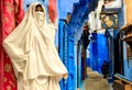 Colorful Moroccan fabrics and handmade souvenirs on the street in the blue city Chefchaouen, Morocco, Africa Royalty Free Stock Photo