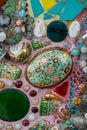 Colorful mosaic tiles and pottery items at Wat Pha Sorn Kaew