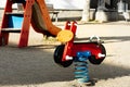 Colorful motorcycle spring rocker in a children\'s park during daylight