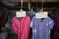 Colorful mountaineer shirts hanging on wooden rack