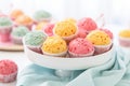 colorful muffins for a baby shower on a white table