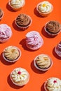 Colorful Muffins On A Bright Orange Background.
