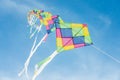 Colorful multi-color kites flying in blue sky Royalty Free Stock Photo