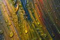 Colorful multicolored paint covered with water drops, theme wallpaper background. Selective focus. Multicolor