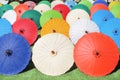 Colorful multicolored paper umbrella group on grass floor, decoration for background