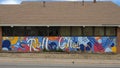 Colorful mural featuring the words Roll \'Chos on a building on the campus of The Uiversity of Central Oklahoma in Edmond.