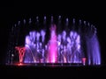 Colorful musical fountain. Magnificent night show of colorful lights, laser beams, music Royalty Free Stock Photo