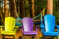 Colorful wooden chairs at rivers edge in the colors of Autumn, w Royalty Free Stock Photo